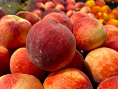 Red peaches on display fresh market retail grocery store Georgia USA