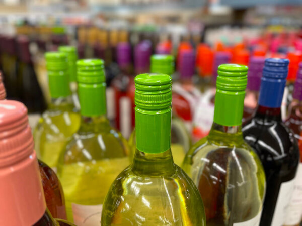 Colorful wine bottle tops and bokeh background in a retail store