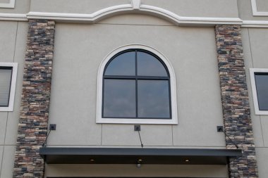 Building facade stucco modern style window and stone work pattern Georgia USA