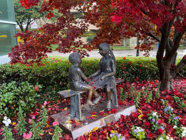 Boy and girl monument in a floral garden Augusta Georgia medical district Childrens Hospital