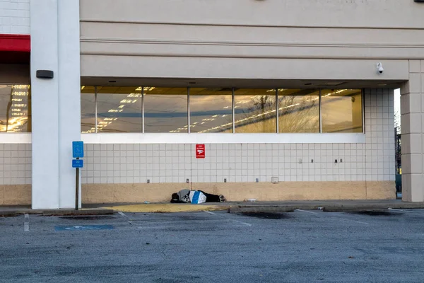 Close up Homeless person sleeping on a sidewalk closed building Augusta Georgia 2020