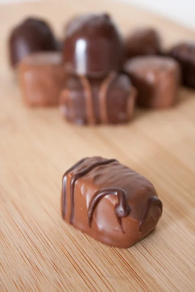 ลูกอมช็อคโกแลตบนพื้นผิวไม้ . — ภาพถ่ายสต็อก
