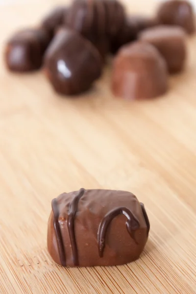 Chocolate candy on a wooden surface. — Stock Photo, Image