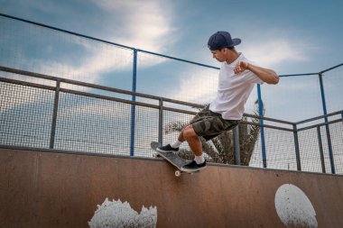 young man skateboarding on the ramp of a skate parkin Lanzarote. 