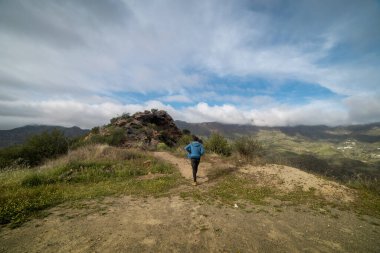 Manzara. Genç adam Gran Canaria 'nın tepesinde yürüyor. kanarya adaları