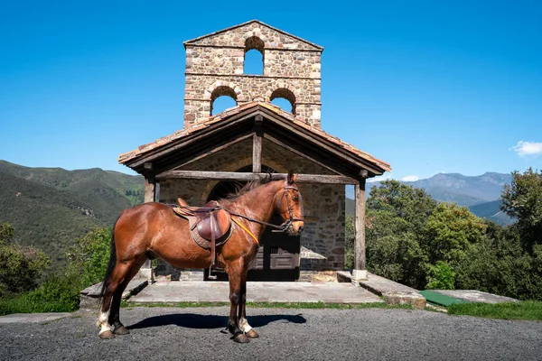 Brown spanish house in S. Miguel hermitage with Picos de Europa in the background. Cantabria. Spain