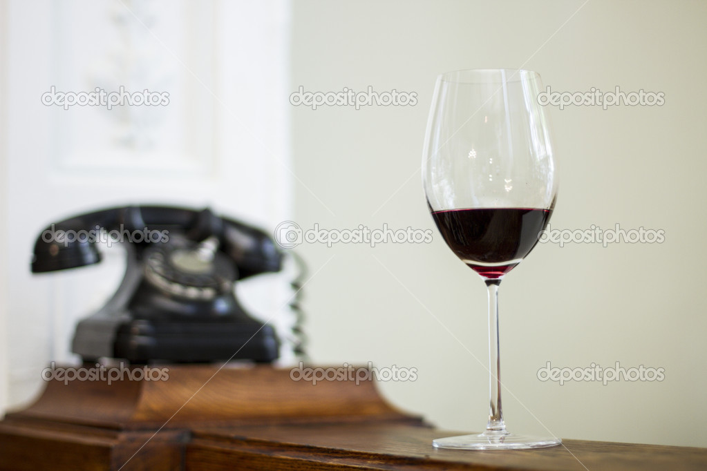 Glass of wine and vintage clock