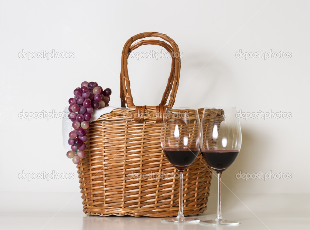 Glasses of wine, basket and grape