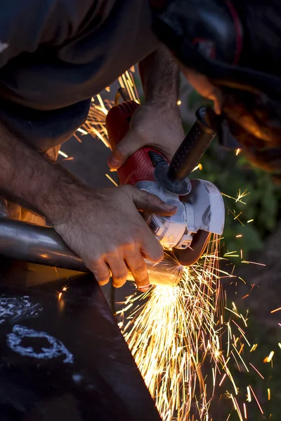 Man workin with iron, sparks — Stock Photo, Image