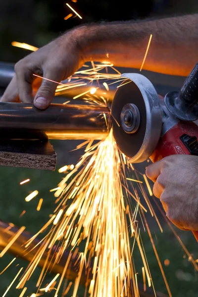 Man workin with iron, sparks — Stock Photo, Image