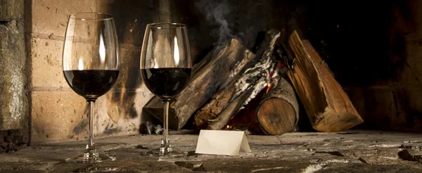 Wine by the fireplace — Stock Photo, Image