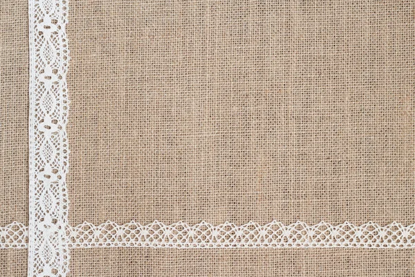 Burlap fundo com rendas — Fotografia de Stock