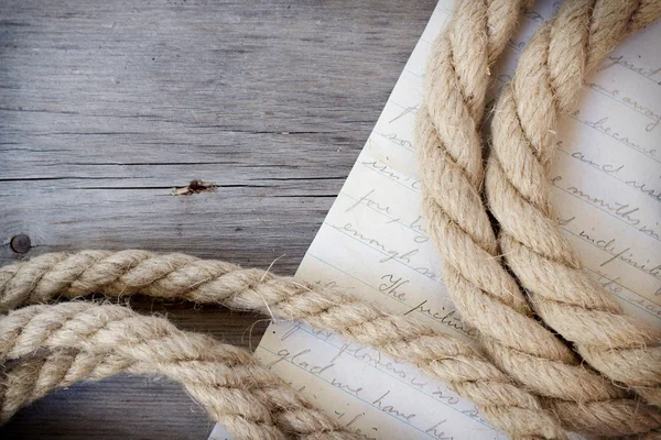 Rope and letter on dark wood — Stock Photo, Image