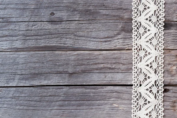 Lace on old wood background — Stock Photo, Image