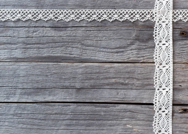 Lace on old wood background — Stock Photo, Image