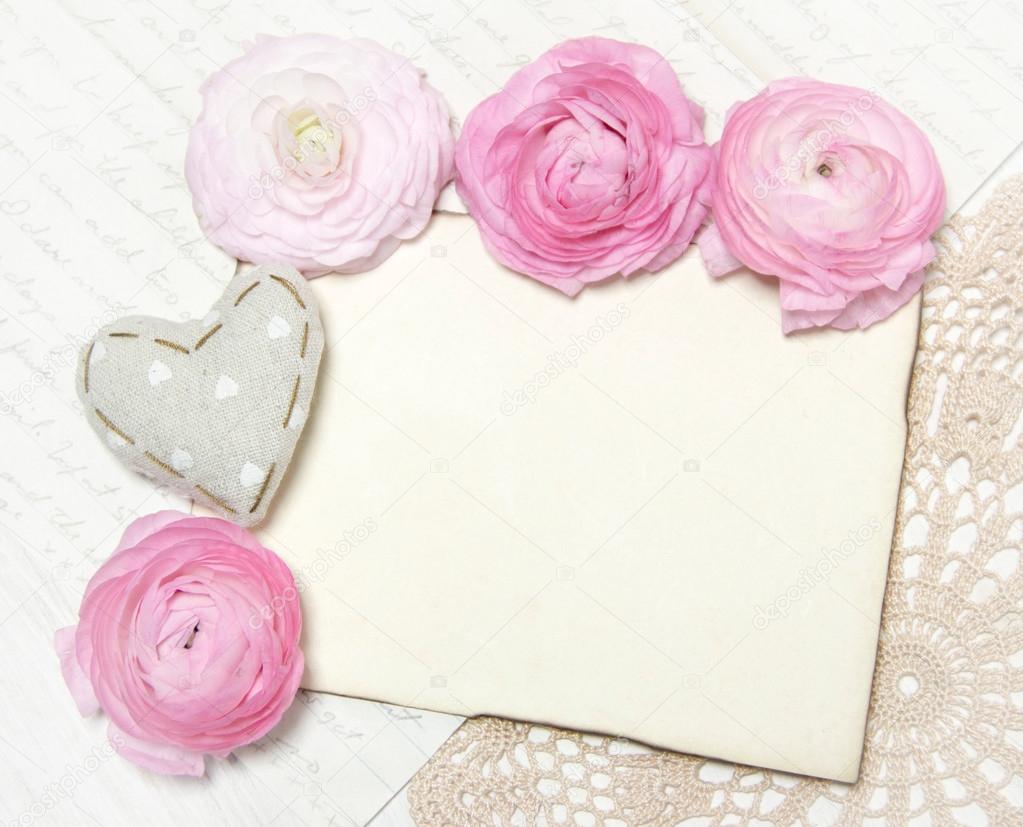 Ranunculus flowers, paper and heart background