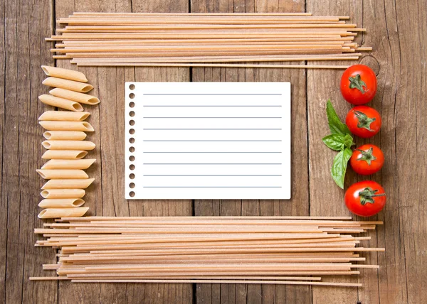 Pasta, tomatoes and basil on wooden background — Stock Photo, Image