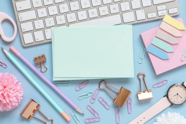 Kağıt kart, Pembe Okul aksesuarları ve açık mavi klavye, Üst Manzara, Model. Not defteri, makas, kalem, ataç, kart ve saati olan kız işyeri. Okula geri dön. 