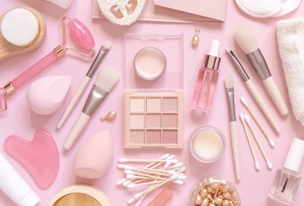 Skin care and makeup products on light pink, top view, banner. Flat lay with natural beauty products and decorative cosmetics. Everyday woman face care routine. Pastel composition
