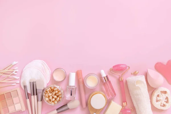 Skin care and makeup products on light pink, top view, copy space. Flat lay with natural beauty products and decorative cosmetics. Everyday woman face care routine