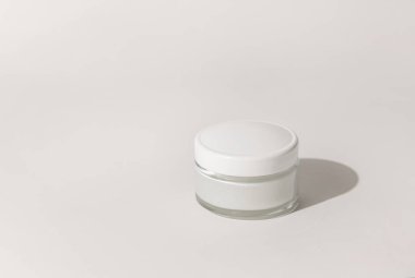 Cosmetic jar with a lid on white close up, mockup. Cosmetic packaging Mockup. Natural homemade cosmetics, monochrome composition, everyday skincare routin