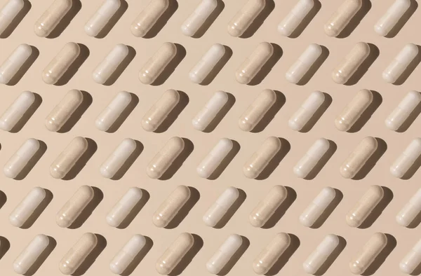 Capsules Light Beige Top View Hard Shadows Creative Pattern Preventive — Foto de Stock