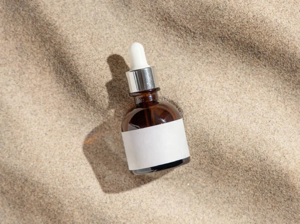Dropper Bottle Blank Label Beige Sand Top View Hard Light — Stock Photo, Image