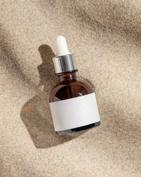 Dropper Bottle Blank Label Beige Sand Top View Hard Light — Stock Photo, Image