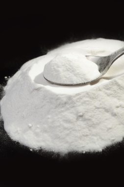 white powder on a spoon. clipart
