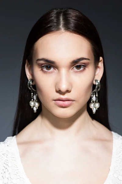 Beautiful brunette with big earrings — Stock Photo, Image