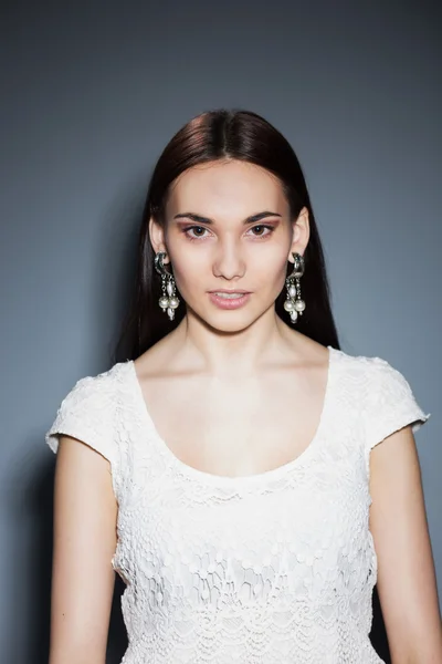 Beautiful brunette with big earrings — Stock Photo, Image