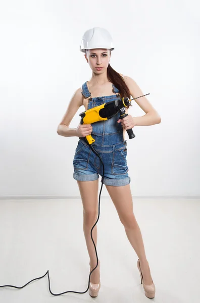 Sexy builder woman with a drill in her hands — Stock Photo, Image