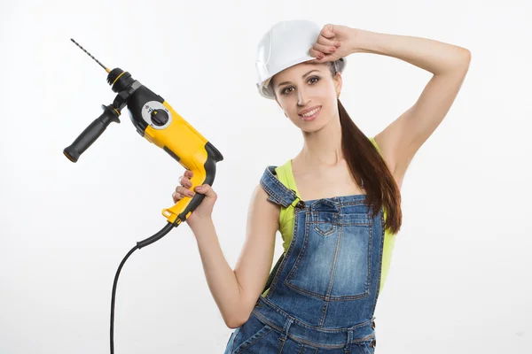 Femme constructeur sexy avec une perceuse dans ses mains — Photo