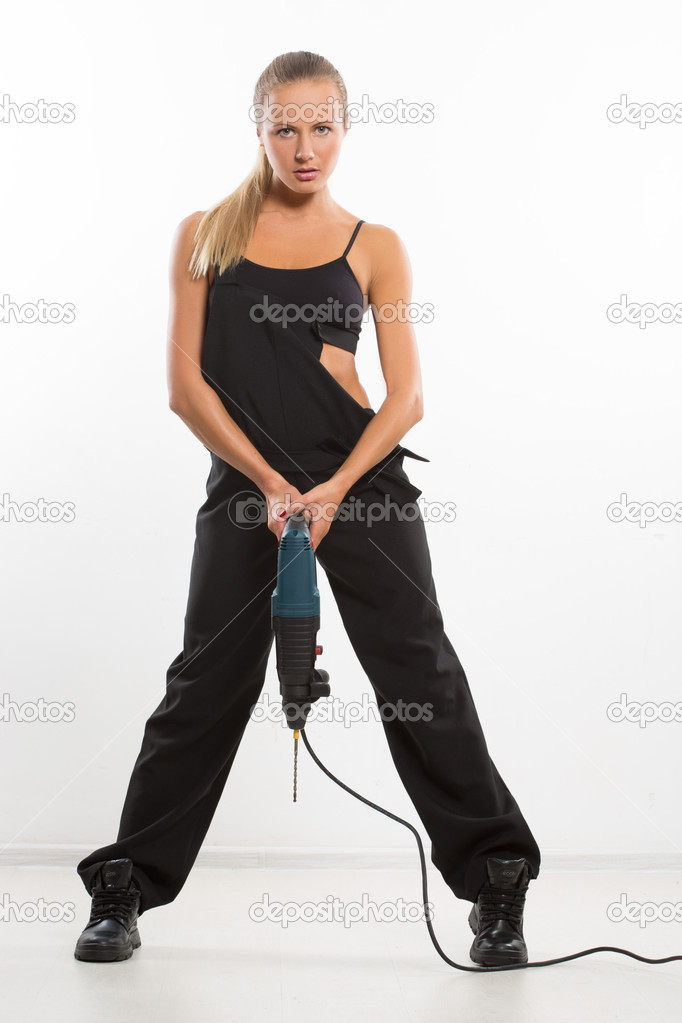 sexy builder woman with a drill in her hands