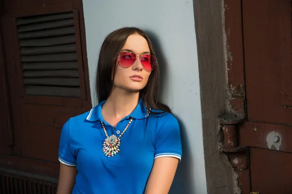 Girl in red glasses and blue shirt — Stock Photo, Image