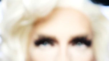 defocus. close-up of the eyes of a travesty actor with eye-catching makeup, focus on the eyes