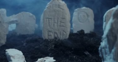 close-up of the inscription the end on the tombstone of an ancient cemetery at night