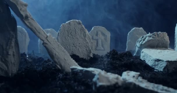 Destroyed decorative crosses and gravestones at night — Stok video