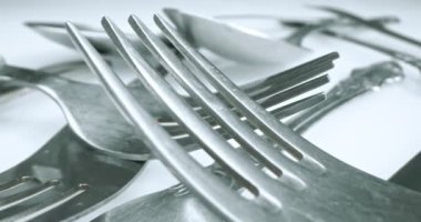 extreme close-up, detailed. stainless steel spoons and forks