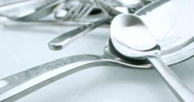 extreme close-up, detailed. stainless steel spoons and forks