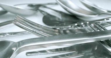extreme close-up, detailed. stainless steel spoons and forks