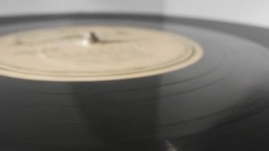 extreme close-up, detailed. Old phonograph needle on a spinning vinyl record