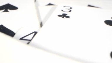 extremely close-up detailed shot of playing cards suits of spades and clubs lying randomly on the table