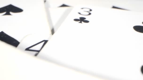 Extremely close-up detailed shot of playing cards suits of spades and clubs lying randomly on the table — Vídeo de Stock