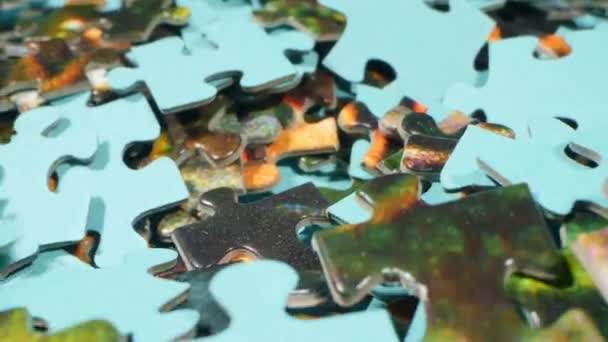 Extremely close-up detailed plan. randomly falling multi-colored puzzles — Stockvideo