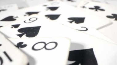 extremely close-up detailed shot of playing cards suits of spades and clubs lying randomly on the table