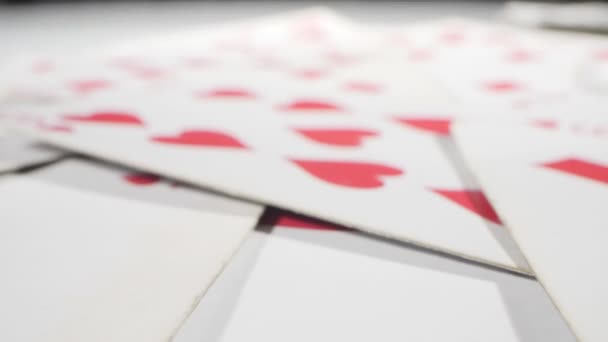 Extremely close-up detailed, randomly lying playing cards of the red suit of hearts and diamonds — Vídeo de Stock