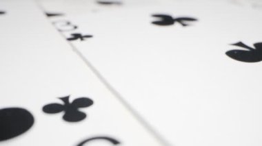 extremely close-up detailed shot of playing cards suits of spades and clubs lying randomly on the table