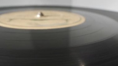 extreme close-up, detailed. Old phonograph needle on a spinning vinyl record