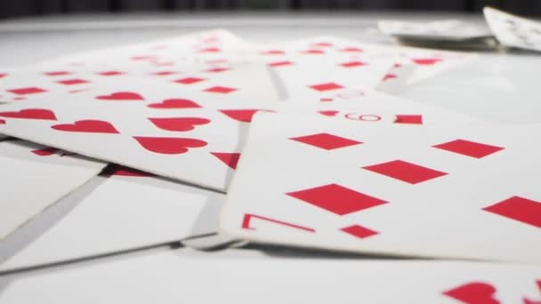 Extremely close-up detailed, randomly lying playing cards of the red suit of hearts and diamonds — Vídeo de Stock